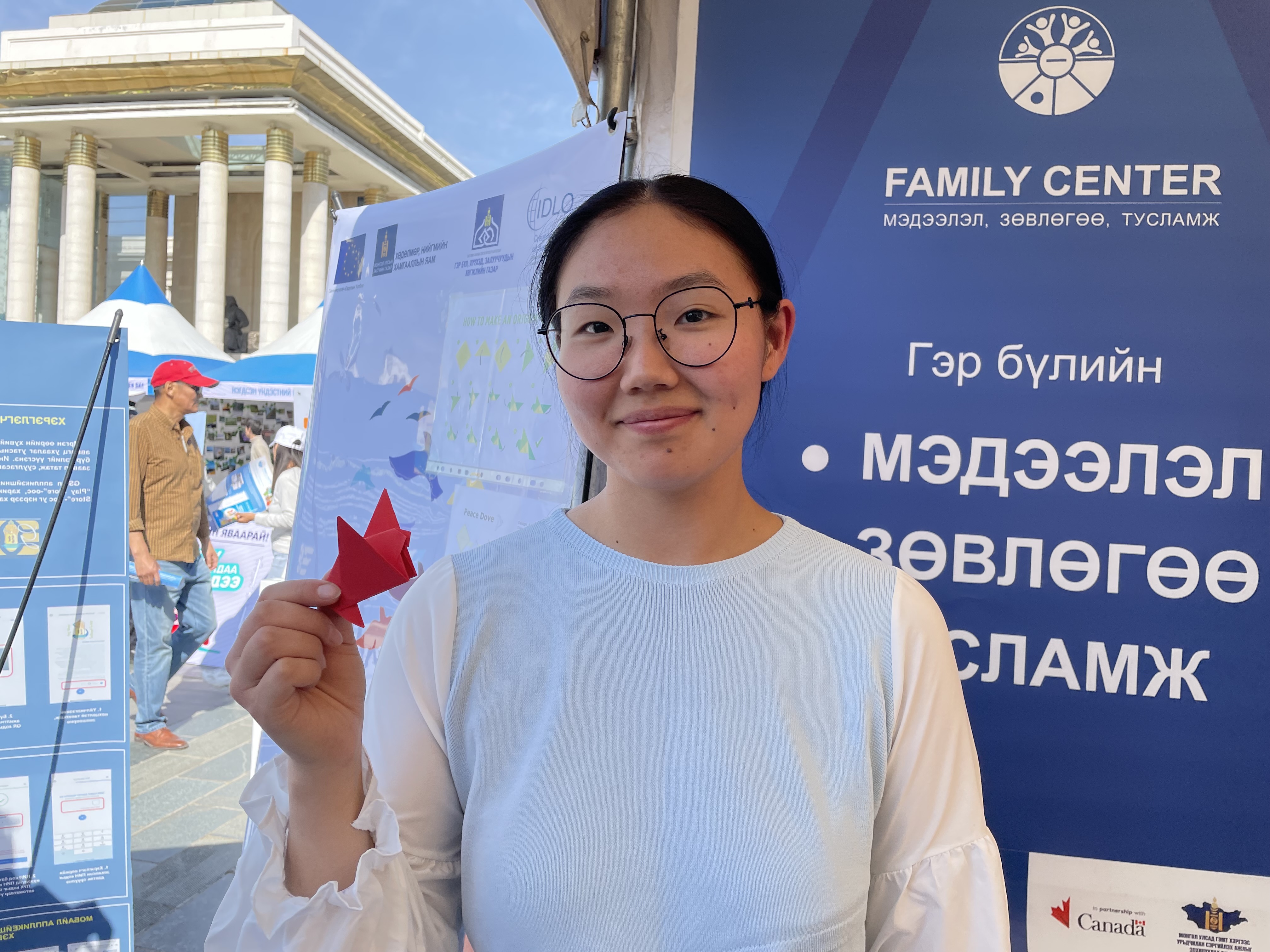 An IDLO intern standing in front of an event display